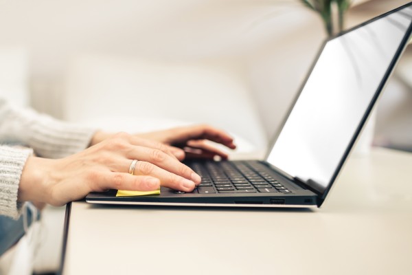 Hände die am Laptop arbeiten