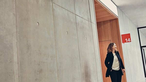loughing young woman is walking down the corridor